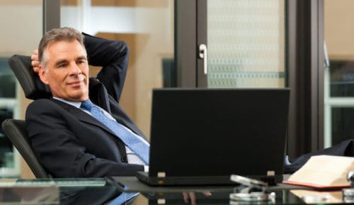 Lawyer growing practice with Mimiran with civil law code and laptop in his office